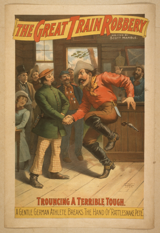 Ein Plakat zeigt eine Gruppe von Menschen drinnen, einer hält eine Waffe, mit Text oben und unten: "Der große Zugraub - Trouching a Terrible Tough".