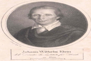 Schwarz-weiß-Porträt von Johann Wilhelm Klein, Direktor des Instituts für Blinde in Wien, der einen weißen Hemd trägt und einen ernsten Gesichtsausdruck hat, sowie deutscher Text unten.